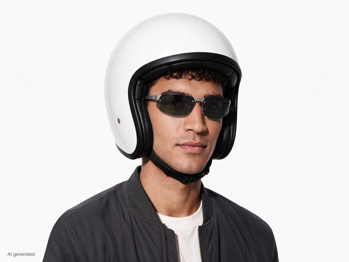 Modello che indossa gli occhiali Aero Speed sotto al casco. Immagine generata con AI partendo dal prodotto reale.